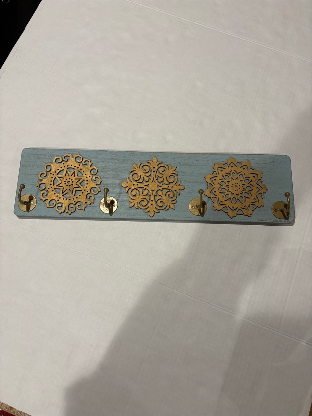 Blue Wall Hook Rack with Gold Medallion Accents